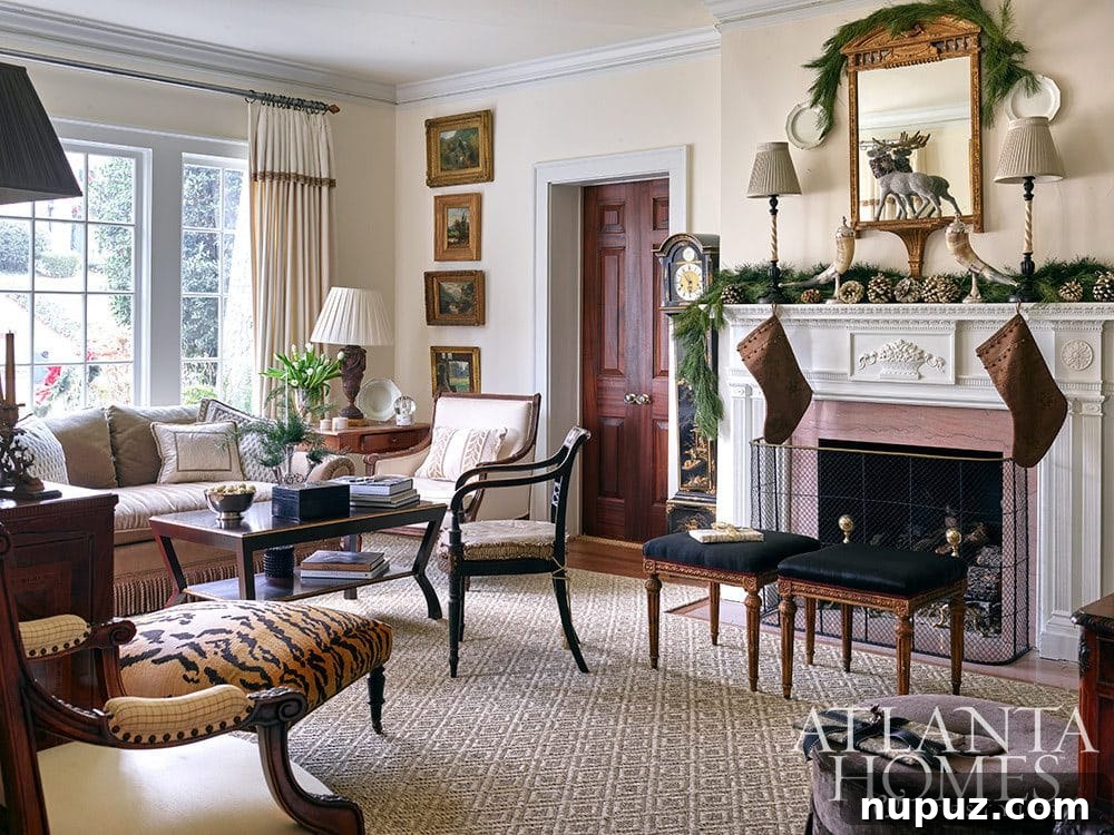 Sophisticated living room adorned with tasteful Christmas decor, including a decorated tree and elegant accents. Interior design by Liza Bryan Interiors.