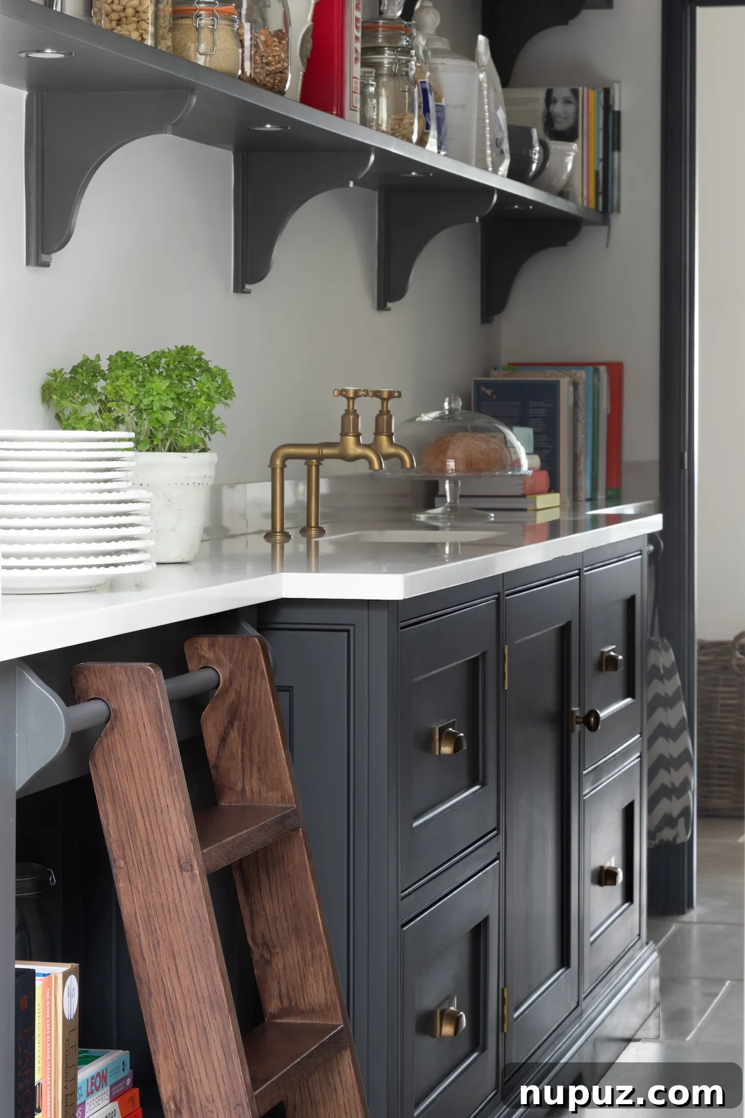 Close-up of organized crockery within a custom cabinet in a Humphrey Munson kitchen, by Paul Craig Photography.