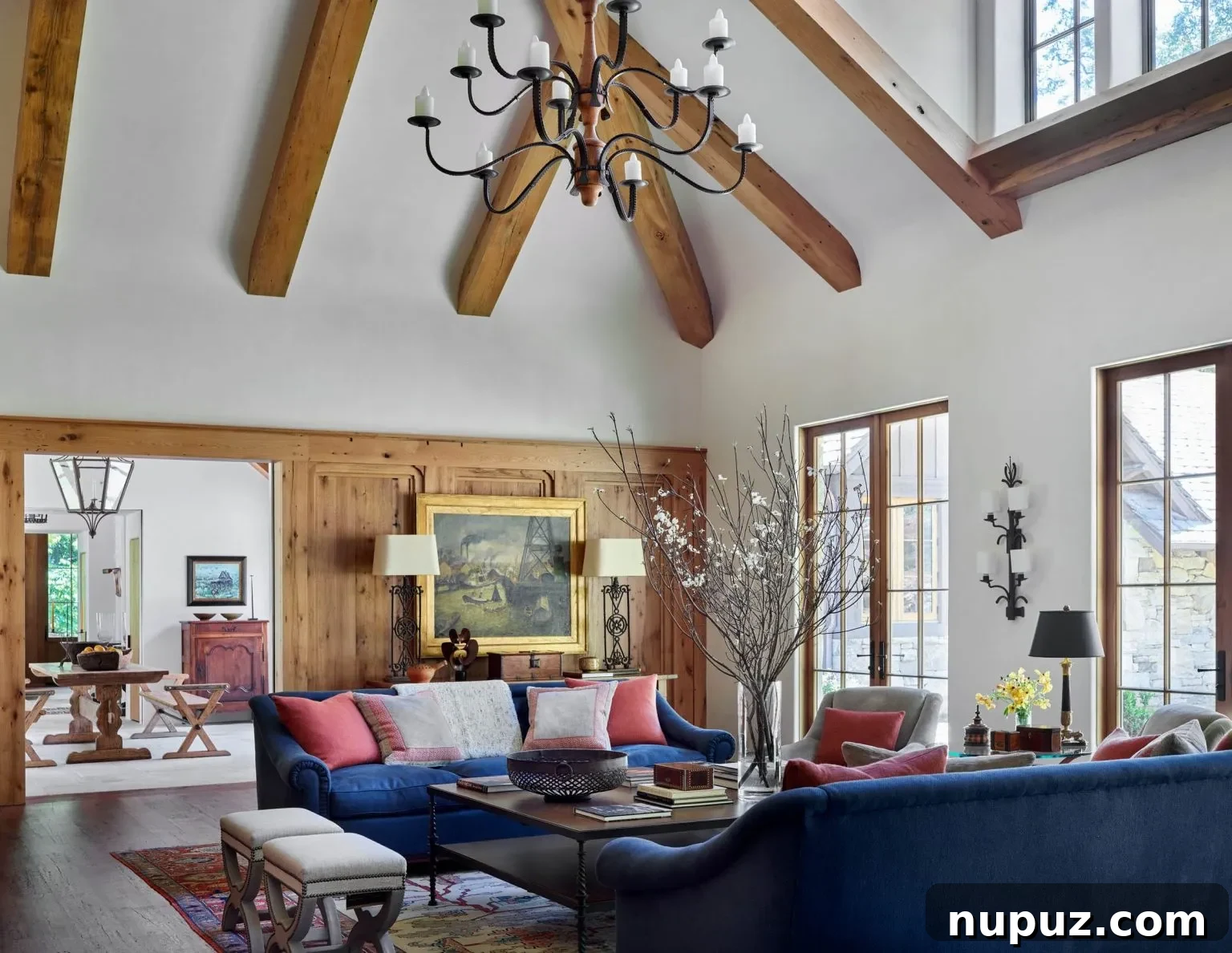 Sophisticated living room with large windows, a refined color scheme, and plush seating by Design Atelier, photographed by Emily Followill.
