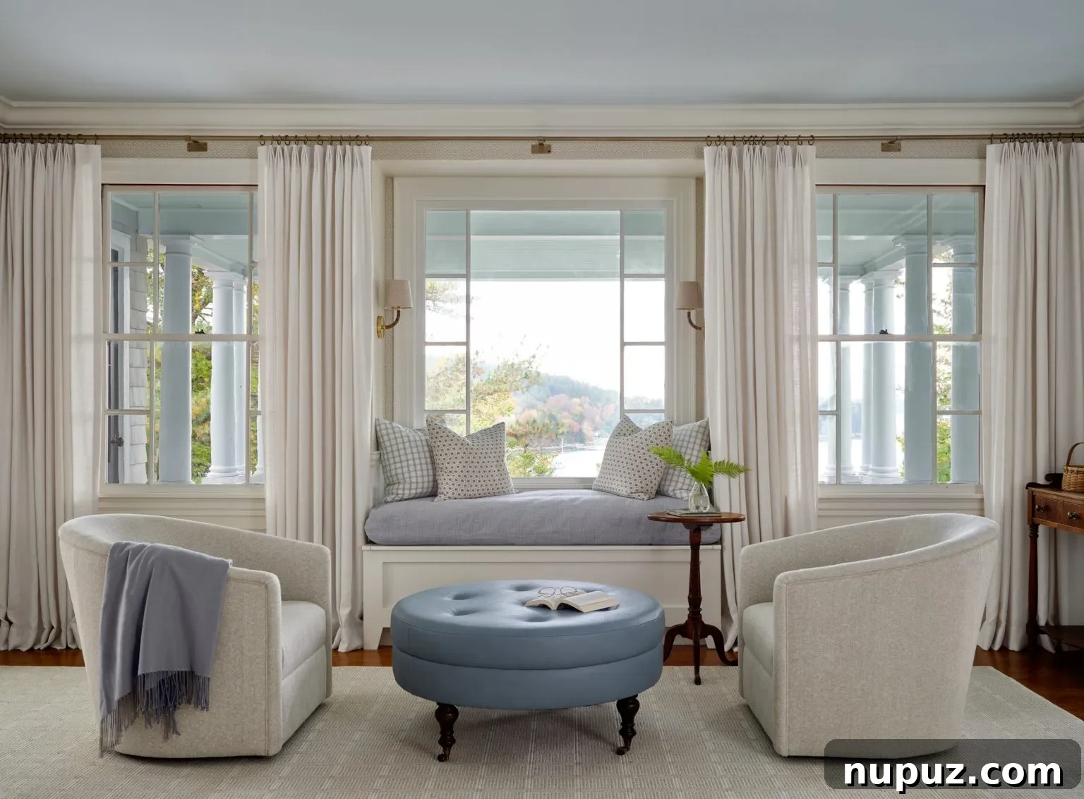 Modern yet classic living room with large windows and clean lines by Design Atelier, photographed by Sean Litchfield.