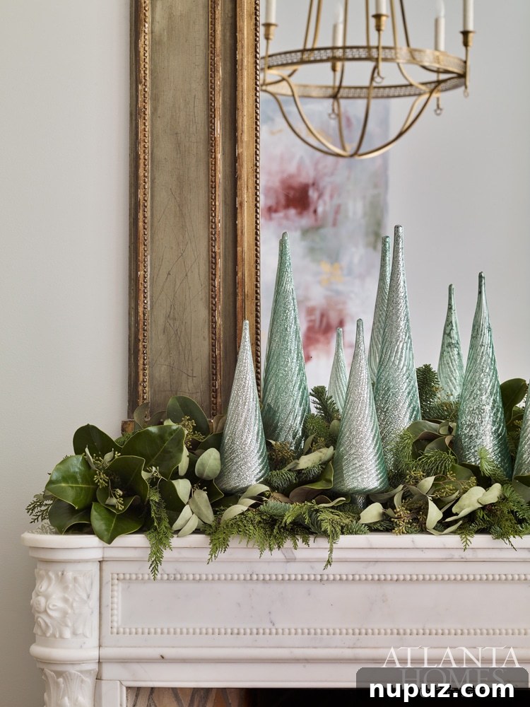 Cozy Christmas mantel featuring a vibrant green garland, white pillar candles, and elegant mirrors reflecting the warm holiday ambiance.
