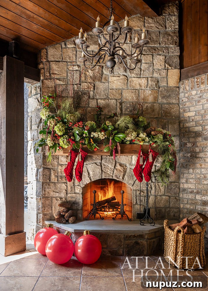 A grand, traditional Christmas mantel with full green garlands, elegant white candles, and festive embellishments in a classic interior, by Lauren Davenport.