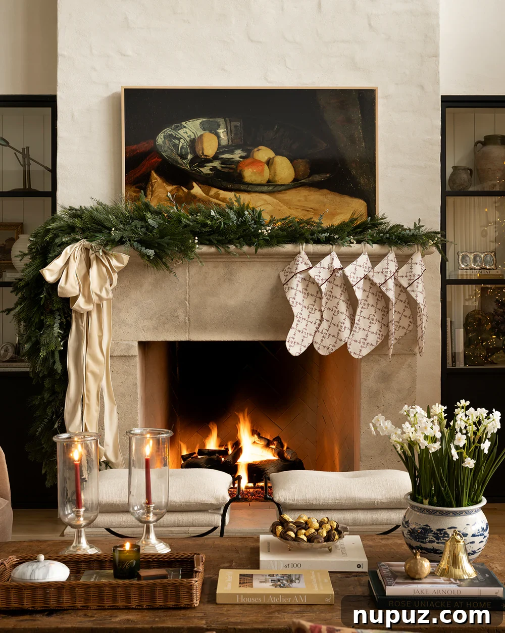 Cozy and inviting Christmas mantel with layered greenery, textured stockings, and a warm, inviting aesthetic from McGee & Co.