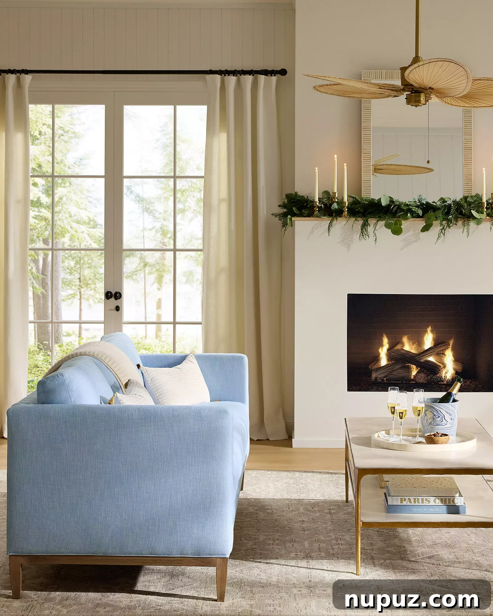 Coastal-inspired Christmas mantel with delicate white garland, natural textures, and elegant gold accents from Serena & Lily.