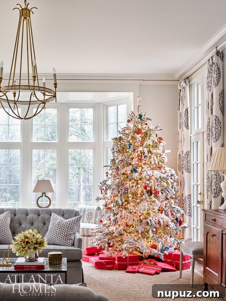 Elegant Christmas tree decorated with classic gold and white ornaments in a grand living space by D. Stanley Dixon and Lynne T. Rankin.