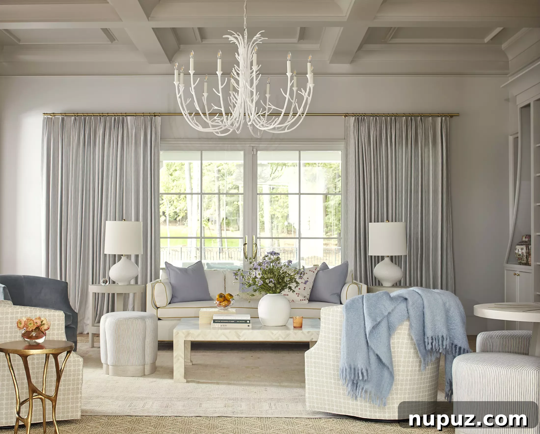 Elegant blue and white living room with a white chandelier by Georgia Street Design, photography by Brie Williams.