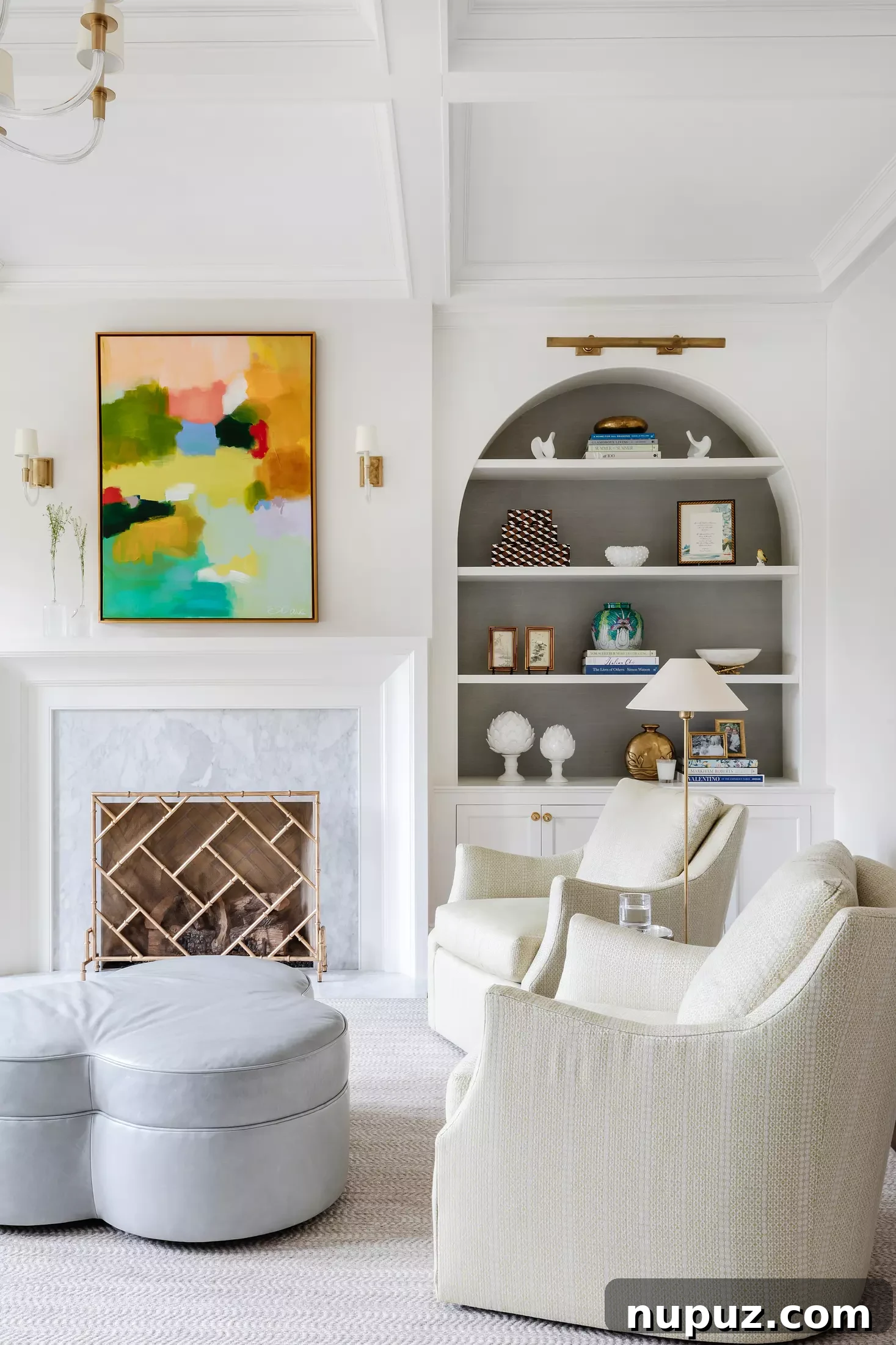 Striking modern living room with a brass Visual Comfort library light and captivating abstract art over the fireplace, a collaboration between Georgia Street Design and Laura Sumrak Photography.