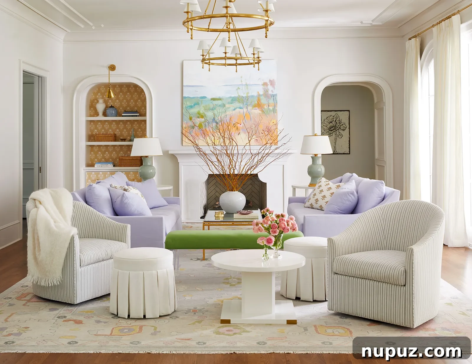 Charming lavender and white living room illuminated by a brass Visual Comfort chandelier, designed by Georgia Street Design, photographed by Brie Williams.