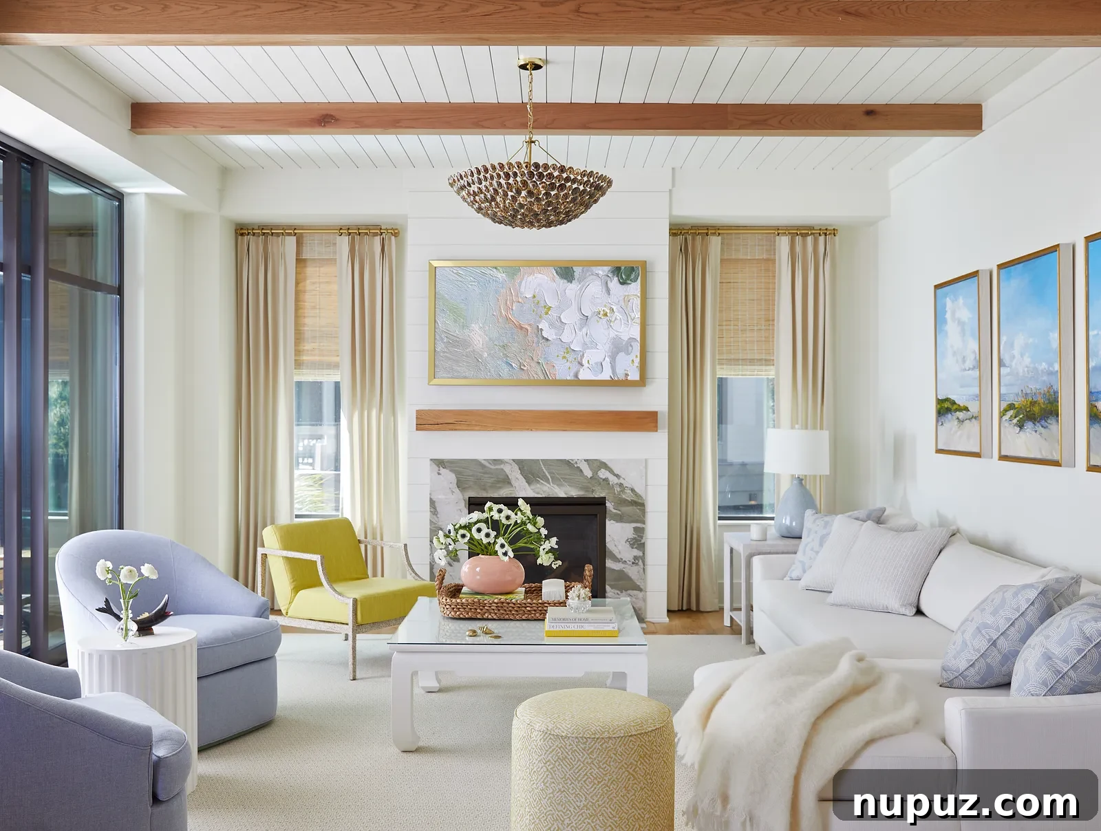 Elegant living room with lavender and white tones, featuring a brass Visual Comfort chandelier, a design by Georgia Street Design, captured by Brie Williams Photography.