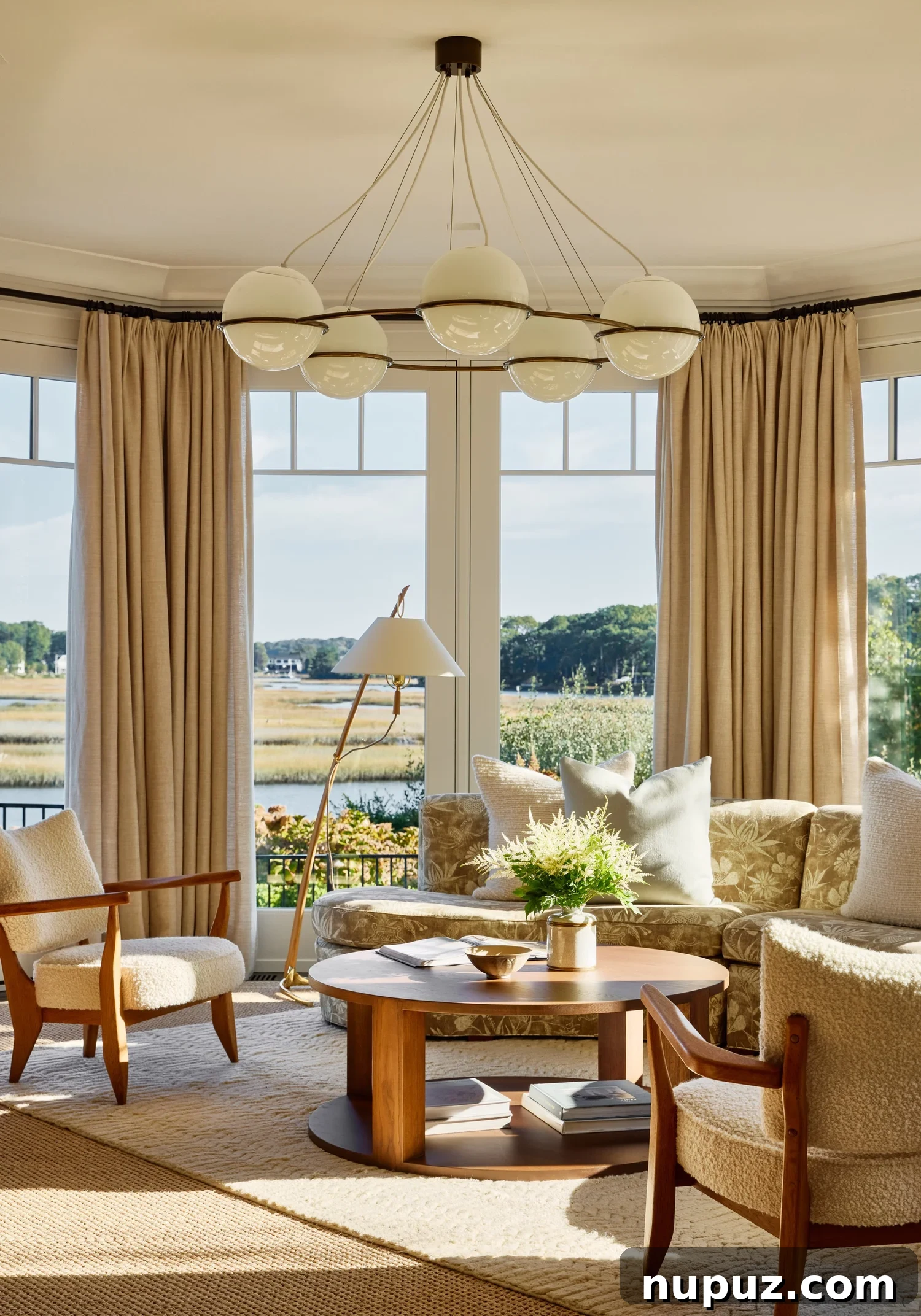 Close-up of the elegant curved sofa, anchor of the modern coastal living room design.