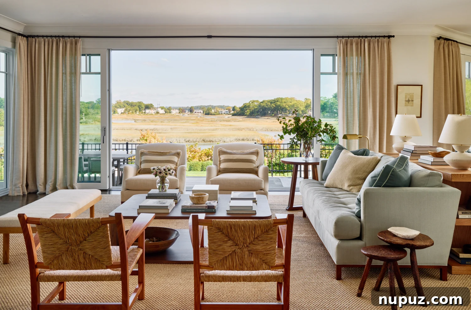 Bright living room featuring a blue and white theme, with expansive views of the waterfront.