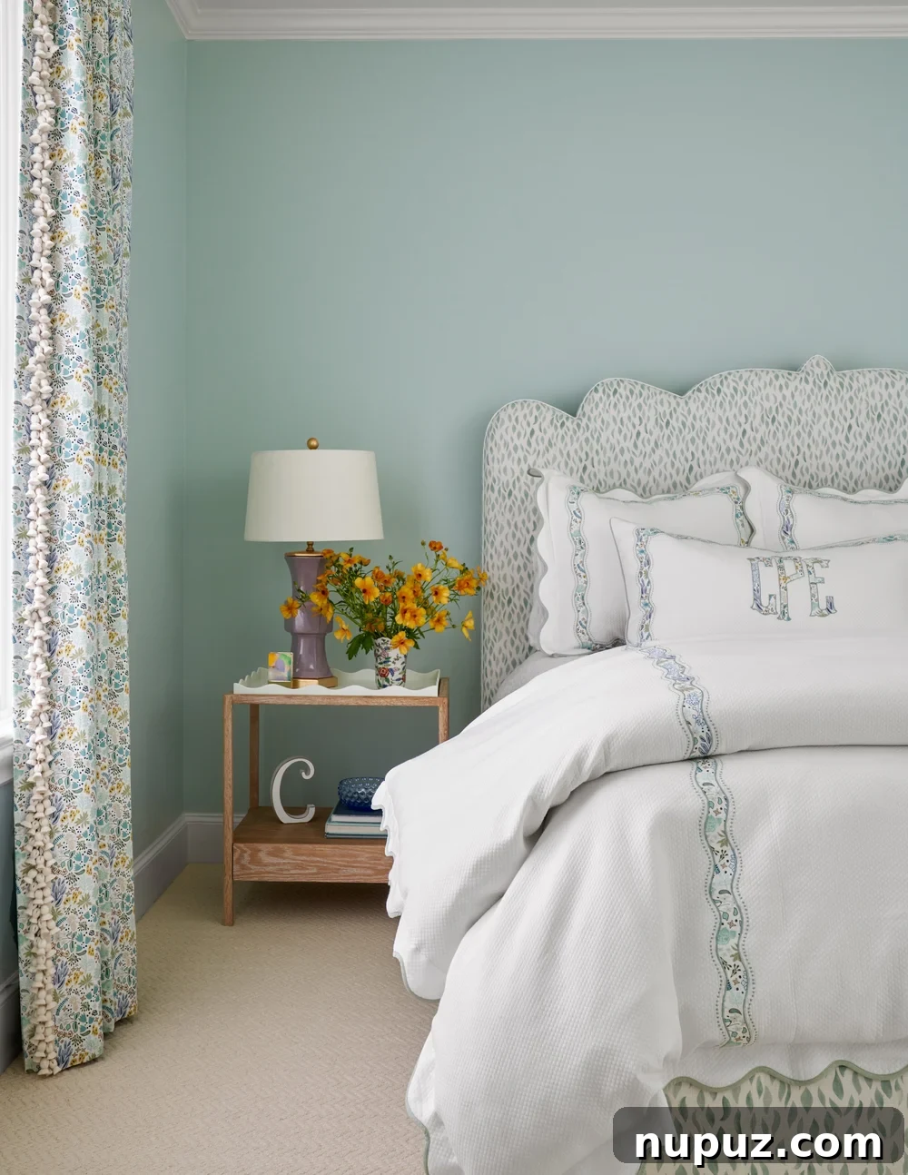 Beautifully layered bedding in soft neutral tones, featuring a patterned duvet cover, crisp white sheets, and a cozy throw blanket, perfect for a classic bedroom design.