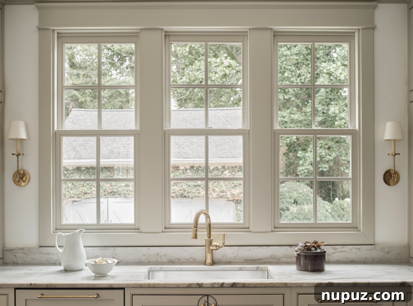 An inspiring kitchen sink with a captivating view, designed by Sabbe Interior Design and photographed by Joseph Bradshaw, emphasizing the blend of functionality and beauty in purposeful home design.