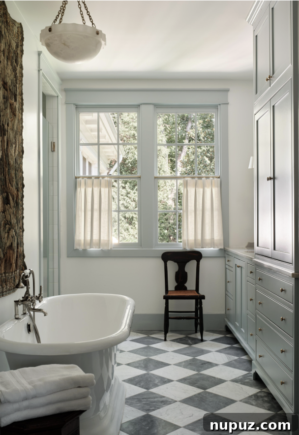A luxurious bathroom by Sabbe Interior Design, featuring a perfect freestanding tub for relaxing and stylish black and white floors, captured by Joseph Bradshaw. This space embodies a purposeful design for tranquility.