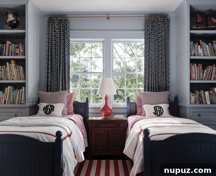 A charming boy's room by Sabbe Interior Design, featuring monogrammed bedding and symmetrical bookcases flanking twin beds, captured by Joseph Bradshaw. This space shows purposeful design tailored for comfort and personality.