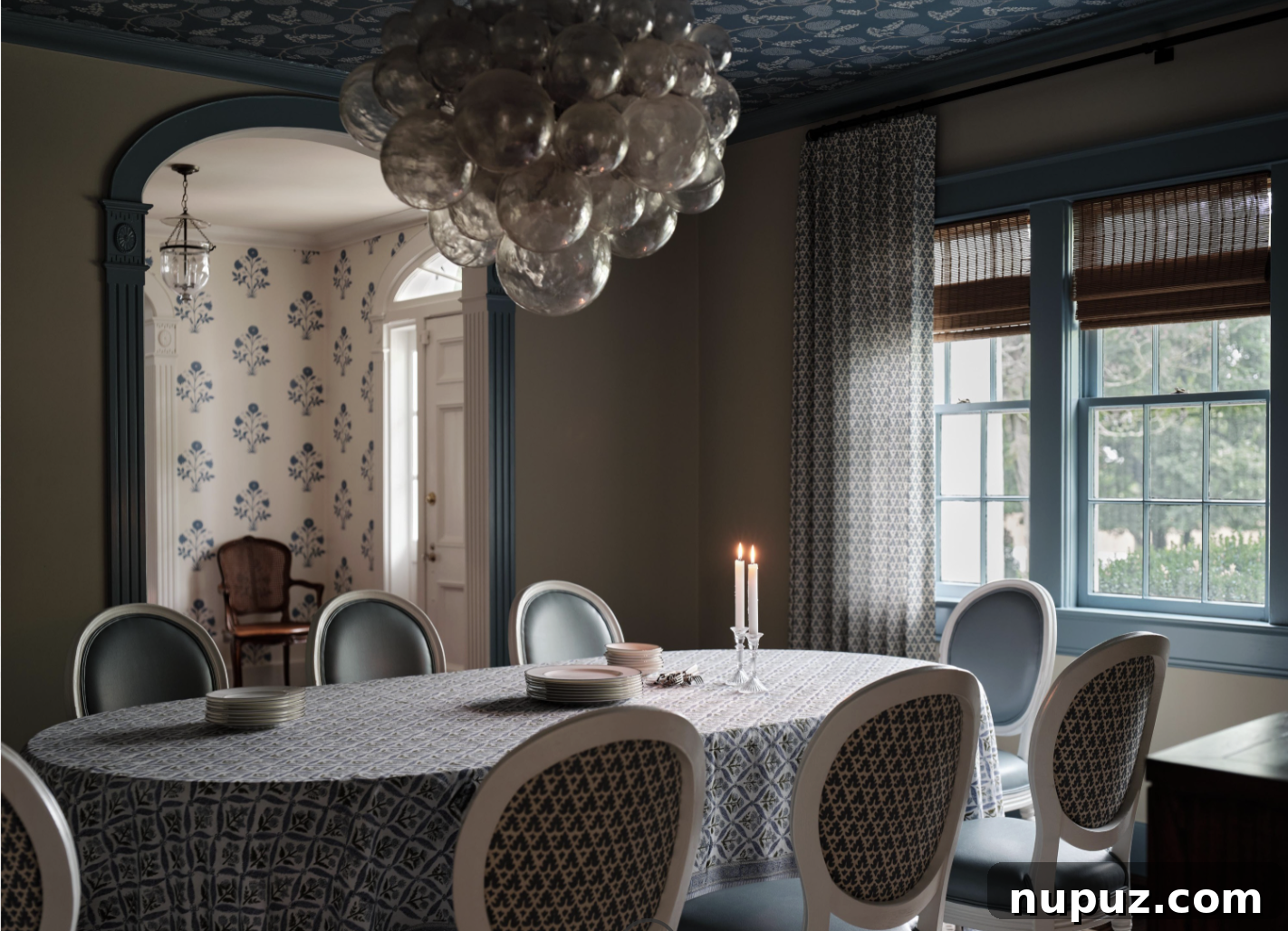 A stunning dining room designed by Sabbe Interior Design, featuring an elegant oval table beneath a beautiful Jennifer Neill Talia chandelier, photographed by Joseph Bradshaw. This space epitomizes dedicated dining.