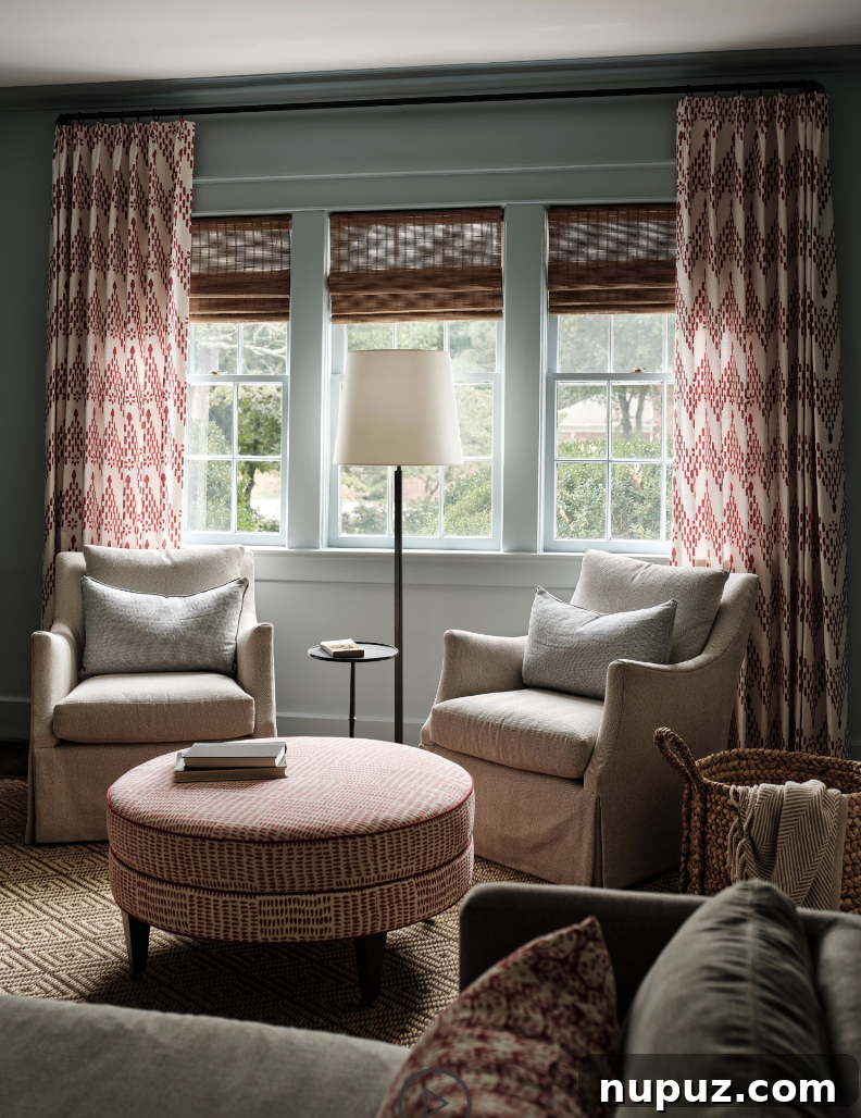 A pair of elegant chairs with an accompanying ottoman create the perfect spot for reading and relaxation, designed by Sabbe Interior Design, captured by Joseph Bradshaw. This cozy corner highlights the charm of purposeful spaces.