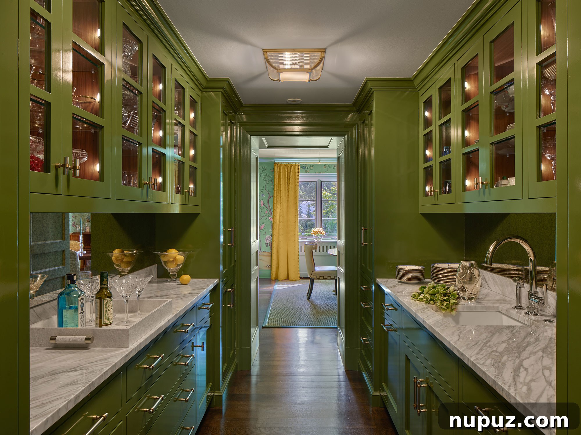 Who doesn't love a green butler's pantry with marble countertops? A luxurious interior detail from Archer & Buchanan Architects, photographed by Halkin | Mason Photography.