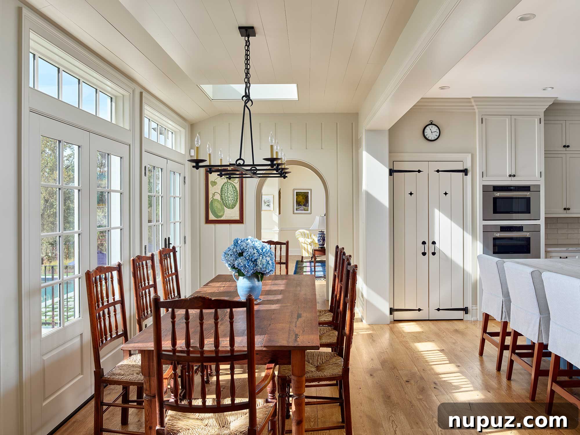 Architectural details of a home from Archer & Buchanan, showcasing beautiful shiplap in the kitchen and an exquisite antique dining room table. Built by Cushing Custom Homes, Inc., with Landscape Architecture by Jonathan Alderson Landscape Architects, Interiors by Barbara Gisel Design, and Photography by Jeffrey Totaro.