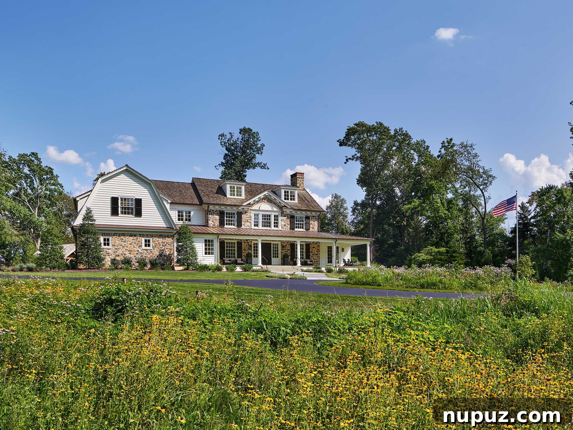Architectural details of a home from Archer & Buchanan, showcasing a beautiful stone exterior on a classic Dutch Colonial home. Photography by Barry Halkin, built by Cullen Construction, Inc., interiors by Barbara Gisel Design, and landscape architecture by Stoney Bank Nurseries.
