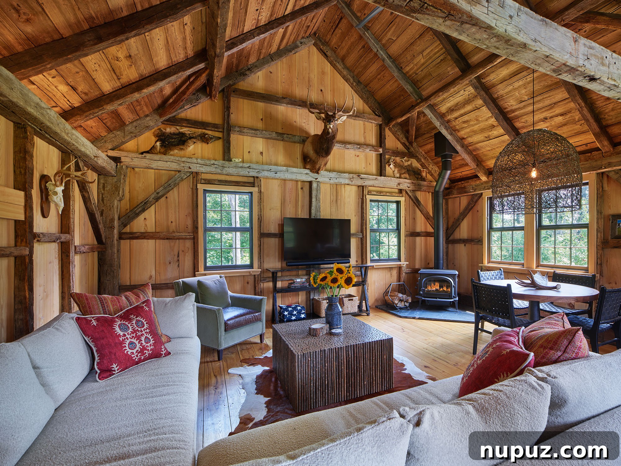 Architectural details of a home from Archer & Buchanan, featuring stunning stained wood beams and walls that create a warm and inviting interior. Photography by Barry Halkin, built by Cullen Construction, Inc., interiors by Barbara Gisel Design, and landscape architecture by Stoney Bank Nurseries.