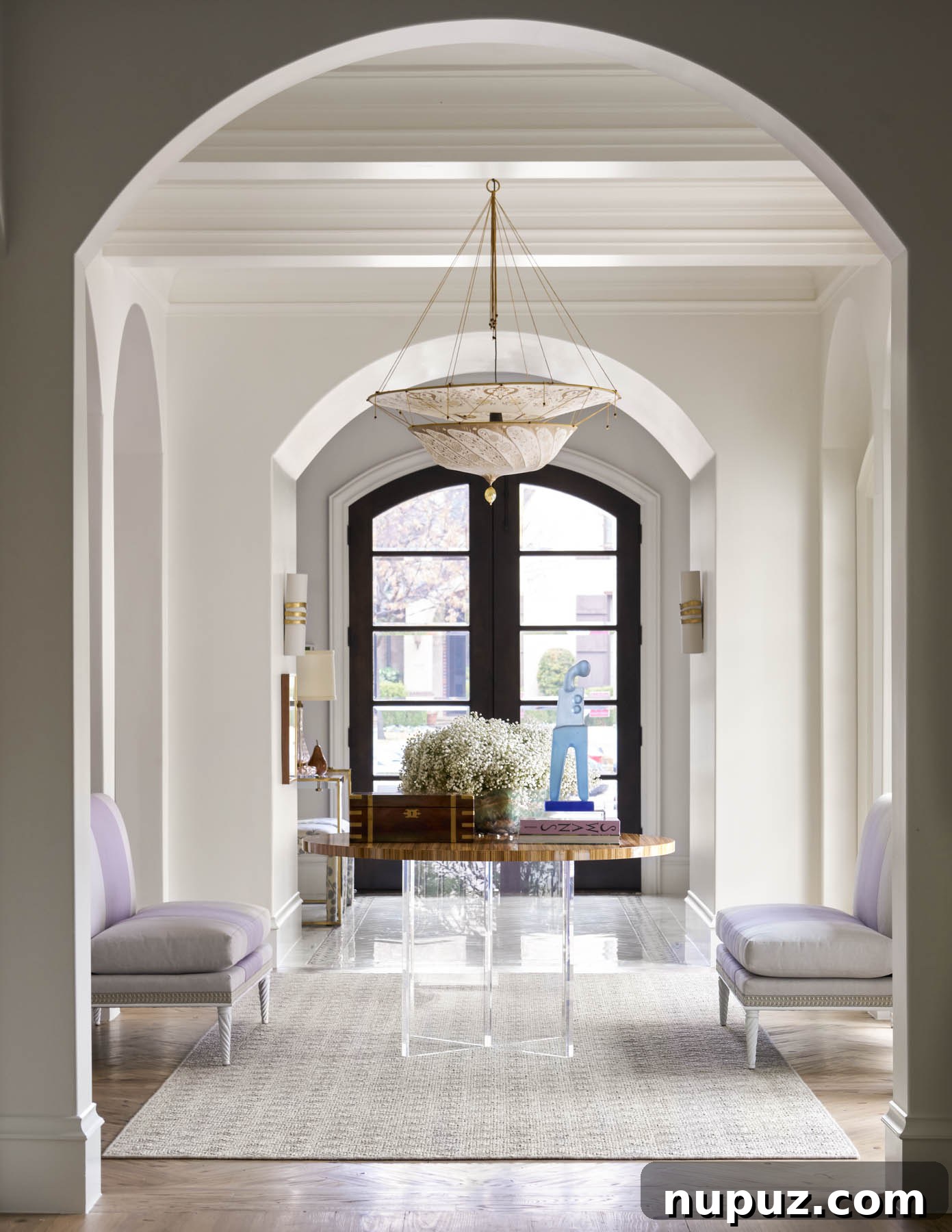 7 Entryway Transformations for an Impressive Welcome 3 Elegant entryway featuring a sleek console table, curated decorative objects, and a large, striking piece of modern art, designed by Collins Interiors.