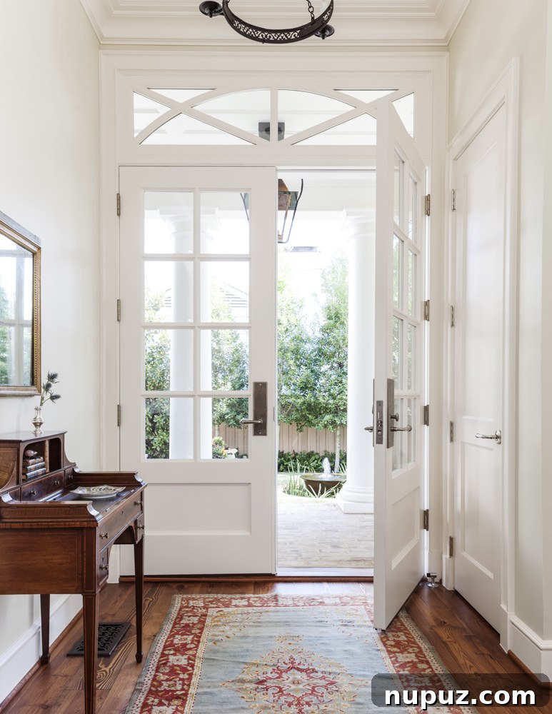 7 Entryway Transformations for an Impressive Welcome 5 Bright and airy entryway featuring natural light, a simple yet elegant console, and understated decor, emphasizing a fresh and welcoming feel by Collins Interiors.