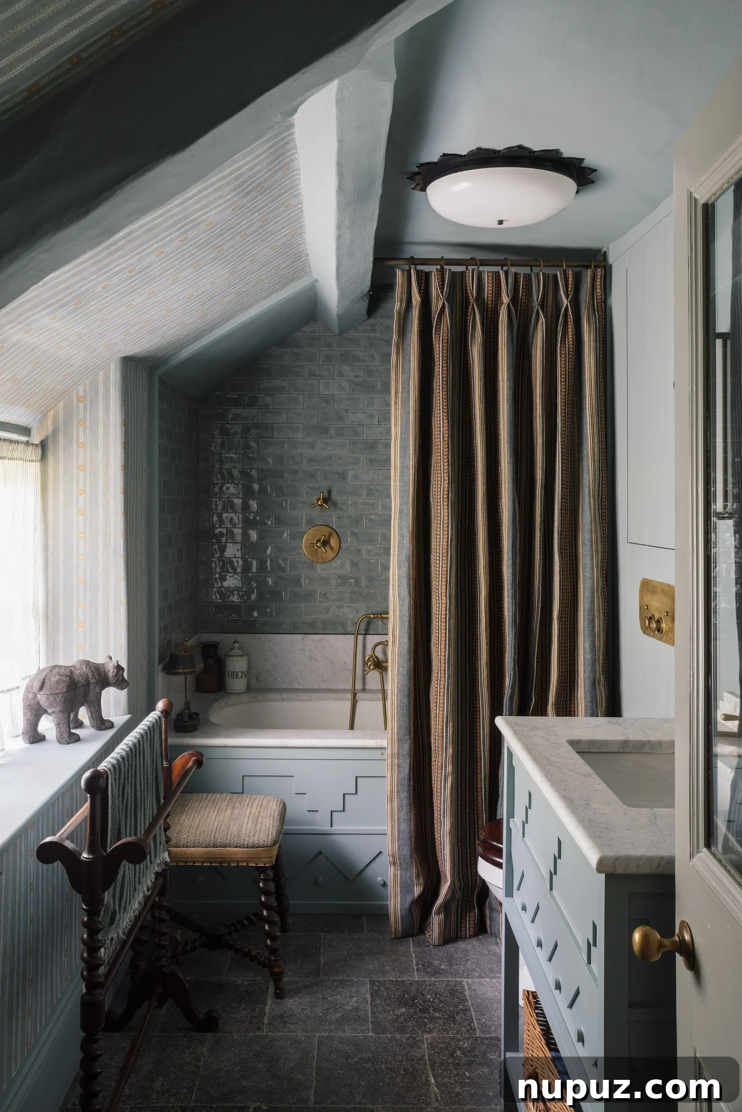 10 Steps to Your At-Home Spa Oasis 4 Serene bathroom featuring gray-blue tiles and matching wall tones, creating a tranquil and cohesive spa-like ambiance, photographed by Alexander James Photography for Hám Interiors.