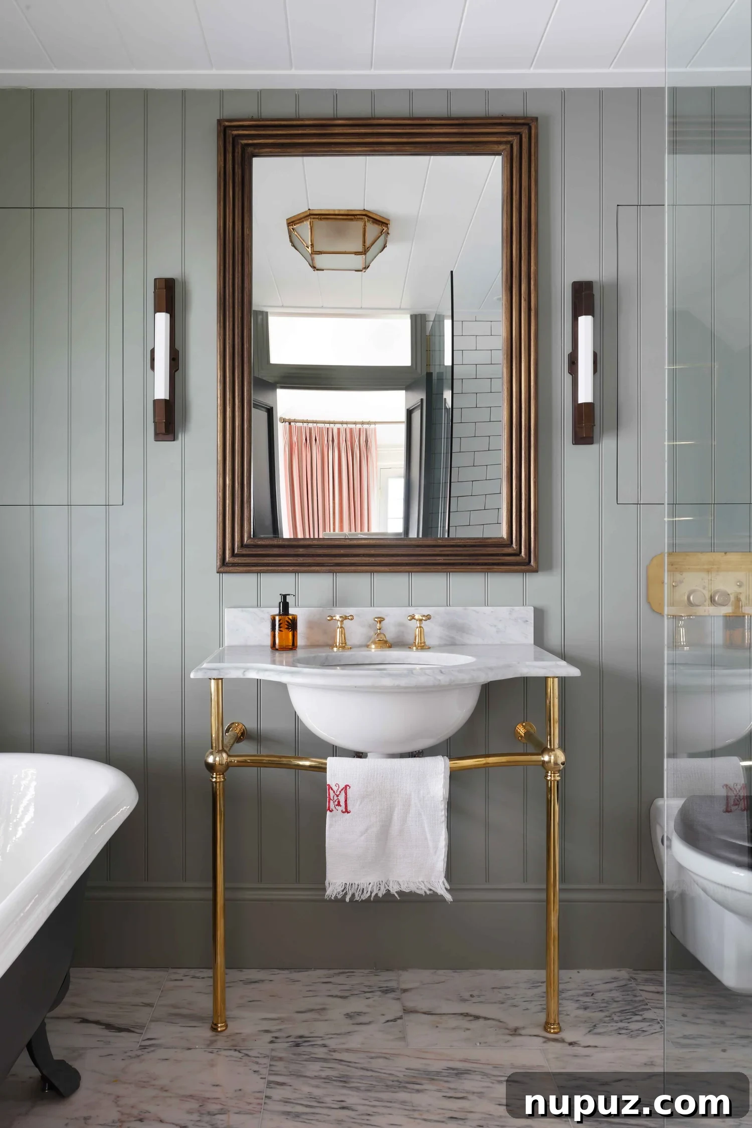 10 Steps to Your At-Home Spa Oasis 5 Sophisticated console sink with gleaming brass hardware, a key feature in creating a luxurious spa-like bathroom, inspired by Hám Interiors and photographed by Alexander James Photography.