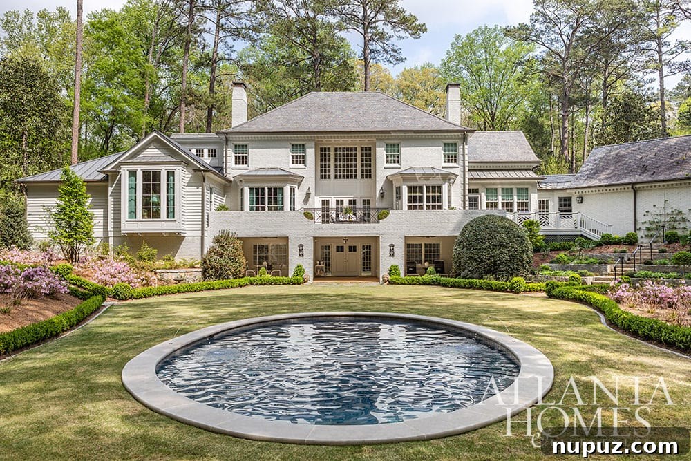 Stunning Atlanta Home Interiors 14 The stunning backyard features a beautiful round pool, meticulously landscaped with lush boxwoods and vibrant azaleas, creating a private and luxurious outdoor retreat.