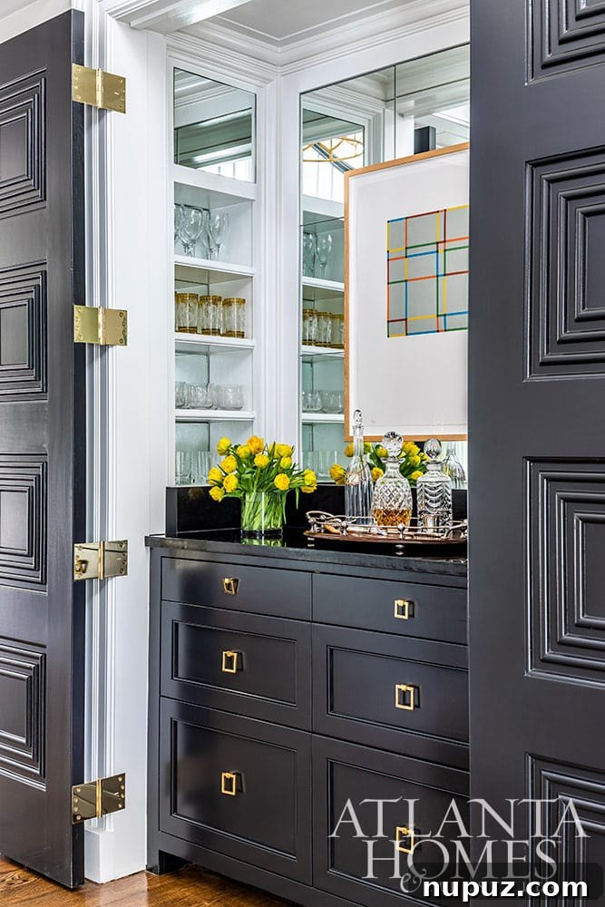 Stunning Atlanta Home Interiors 3 A beautifully designed home bar featuring dark charcoal gray cabinetry, sleek countertops, and sophisticated lighting, perfect for entertaining guests.