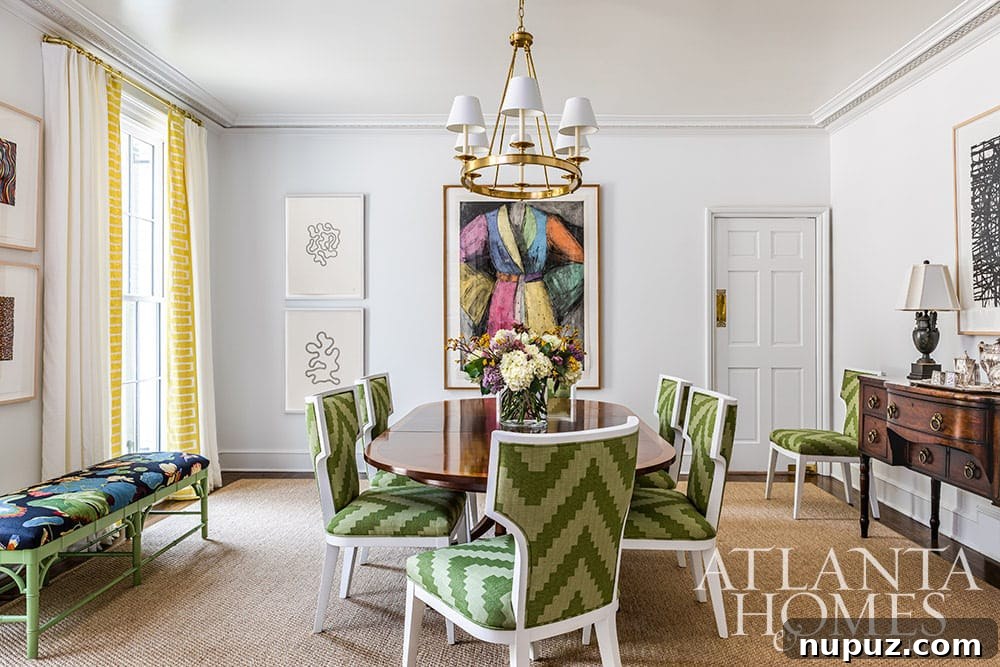 Stunning Atlanta Home Interiors 4 A sophisticated dining room featuring a china cabinet with an elegant blue wallpaper backdrop, adding a subtle pop of color and texture.