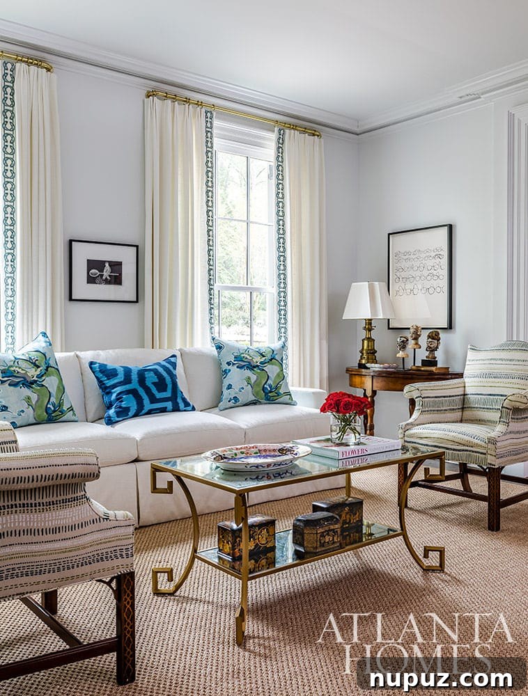 Stunning Atlanta Home Interiors 6 An inviting living room with a rich blue painted wall, accented by a vibrant red art piece, creating a dynamic and striking color contrast.