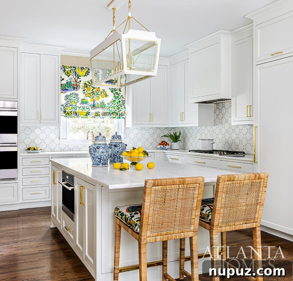 Stunning Atlanta Home Interiors 8 A pristine white kitchen featuring elegant cabinetry, modern appliances, and a unique lemon tree Quadrille fabric accent, adding a touch of nature-inspired charm.