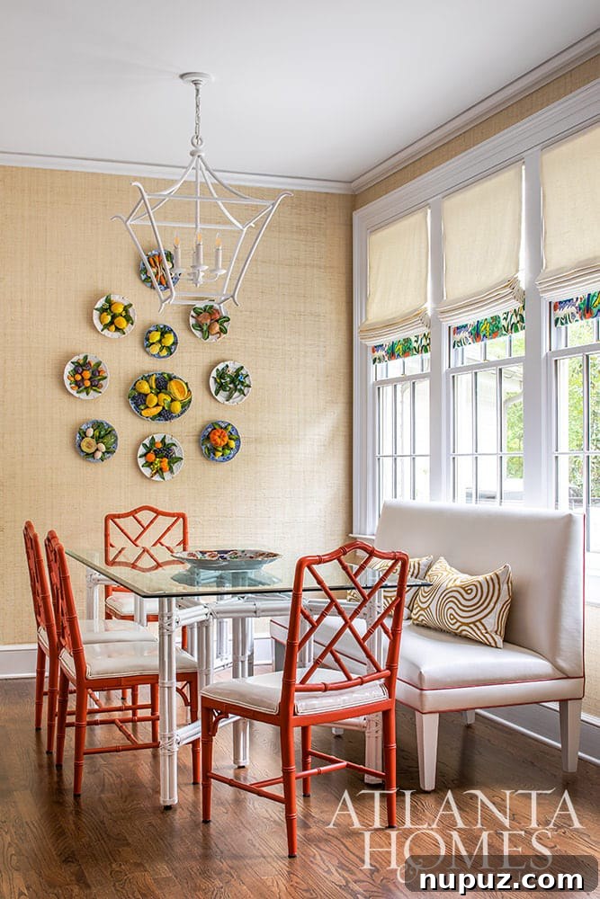 Stunning Atlanta Home Interiors 9 A charming breakfast room adorned with grasscloth wallpaper and striking red bamboo dining chairs, creating a vibrant and textural dining experience.