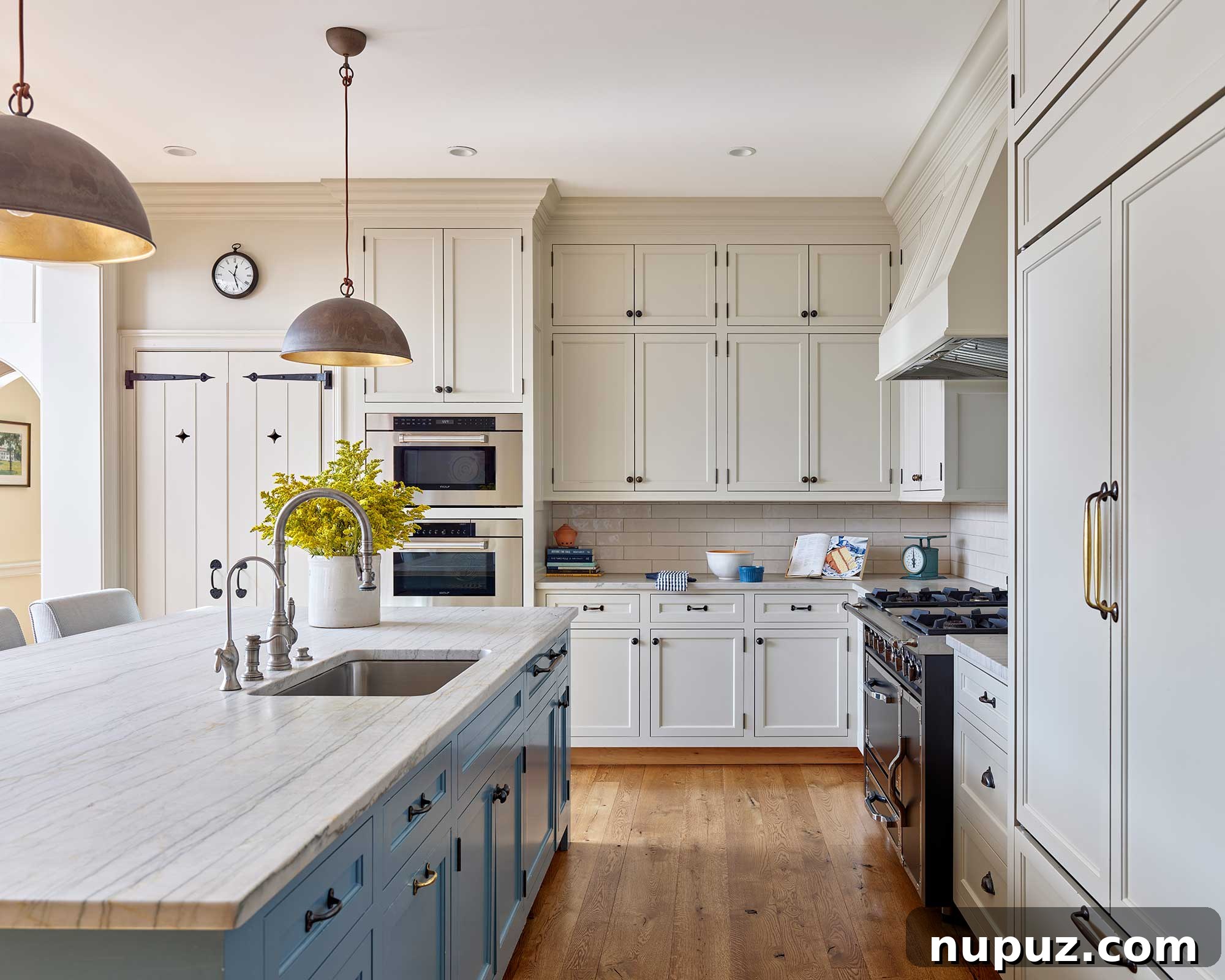 Bright white farmhouse kitchen with black iron hardware, large island, and ample natural light