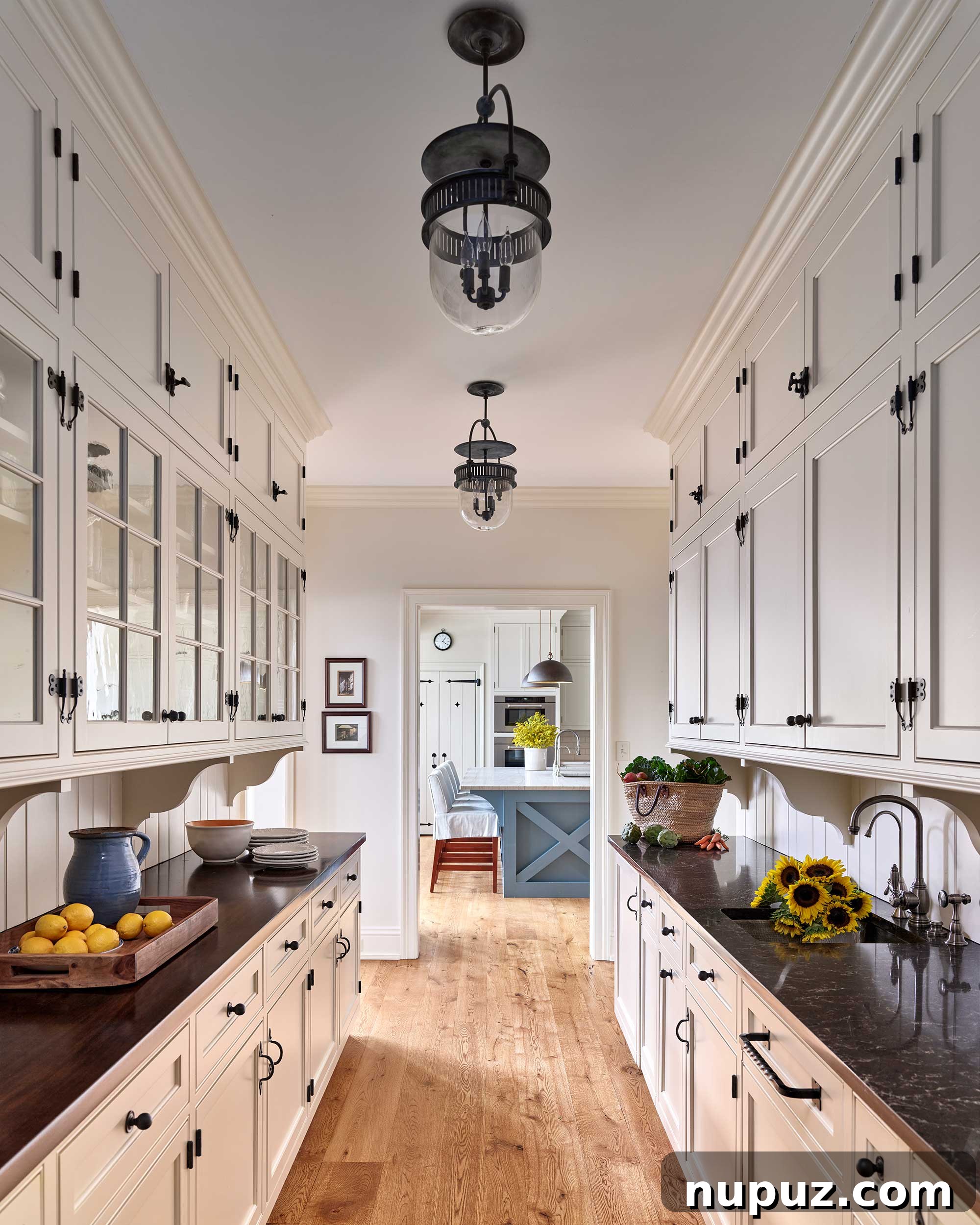 Farmhouse kitchen featuring white cabinetry, black hardware, and an inviting dining area, designed for modern family living