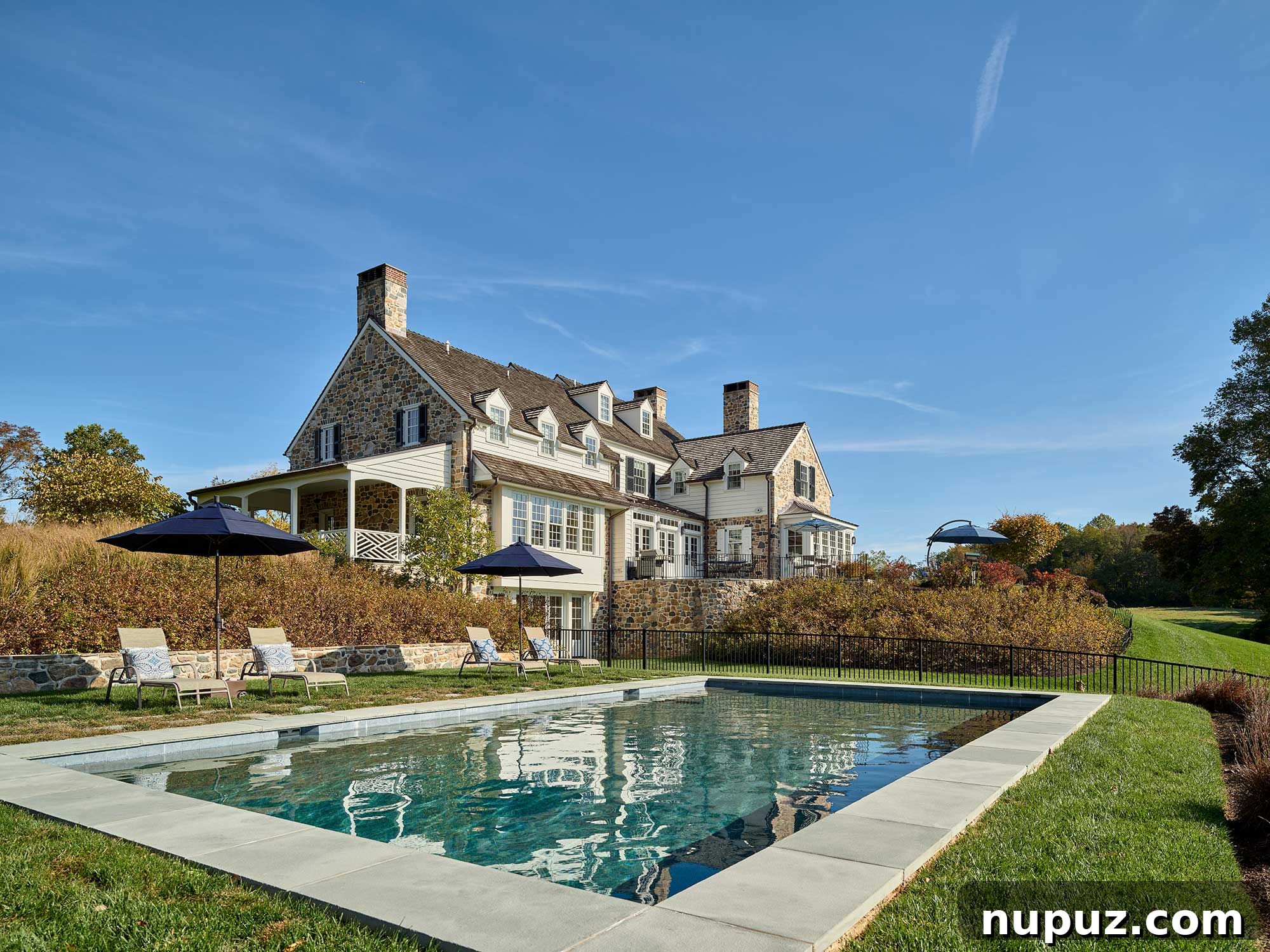 Beautiful farmhouse pool and meticulously designed landscaping, creating a luxurious outdoor retreat