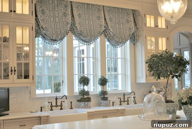 The Enchanted Home's Blue and White Spell 2 Elegant blue and white kitchen island decor with flowering plants