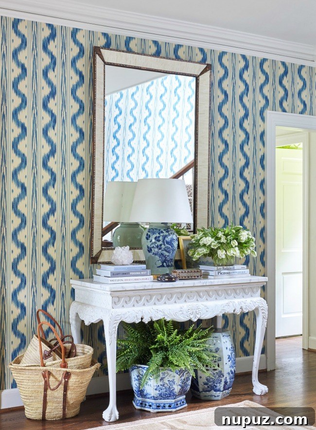 flowers on entry table by Sarah Bartholomew with quadrille wallpaper