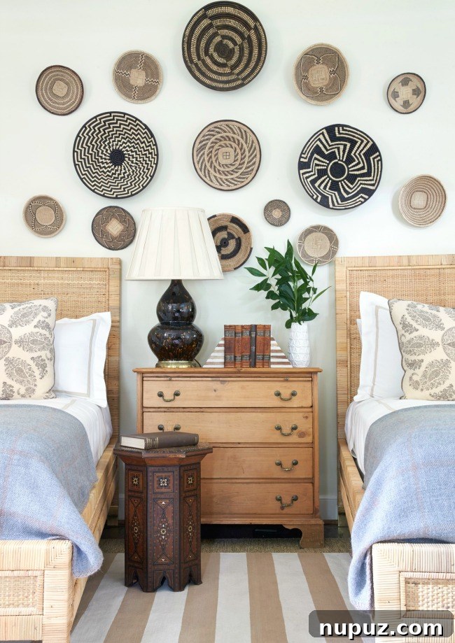 A chic bedroom designed by Sarah Bartholomew featuring twin beds with elegant British Colonial touches, creating a sophisticated and inviting space.