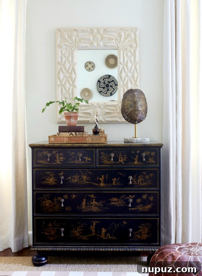 An elegant chest of drawers in a Sarah Bartholomew bedroom, featuring classic details and tasteful decor.