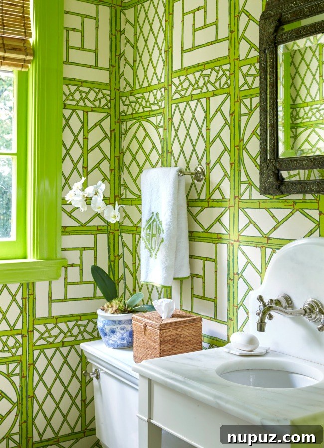 An elegant green bathroom in Sarah Bartholomew's Nashville home, showcasing a blend of classic fixtures and refreshing color.