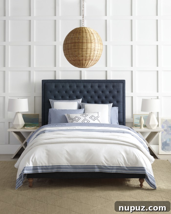 A serene blue and white bedroom with textured bedding, a woven headboard, and natural light, by Serena & Lily.