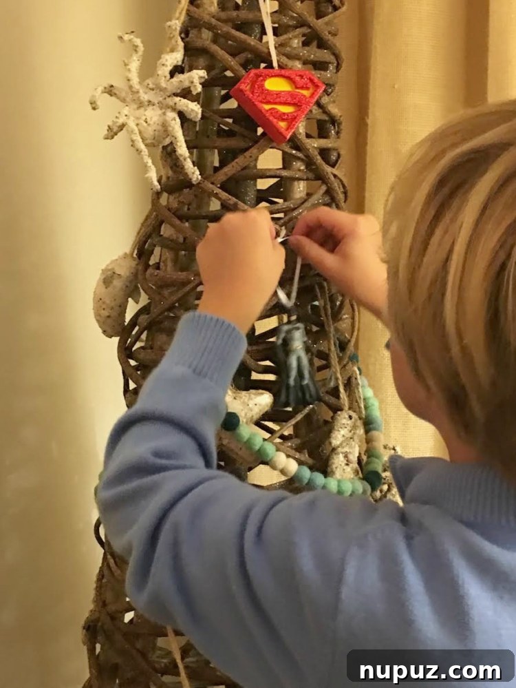 Hallmark Magic: Bringing the Holidays Home 6 Little Will's reaction to a gift wrapped in Inspirations from Hallmark Batman wrapping paper, featuring a Batman ornament as a festive embellishment.