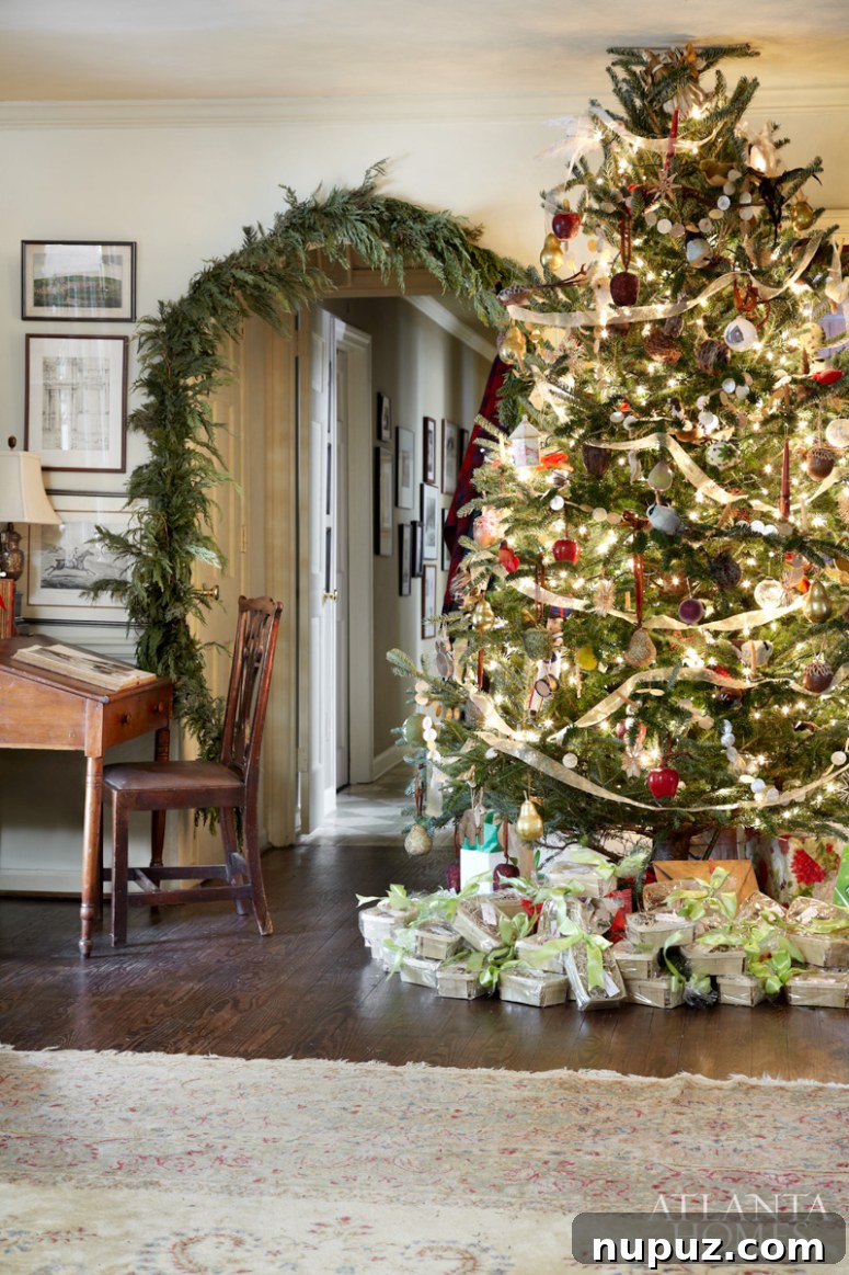 Elegant Buckhead living room with a towering Christmas tree adorned with white and silver ornaments, a cozy fireplace, and classic holiday furnishings.