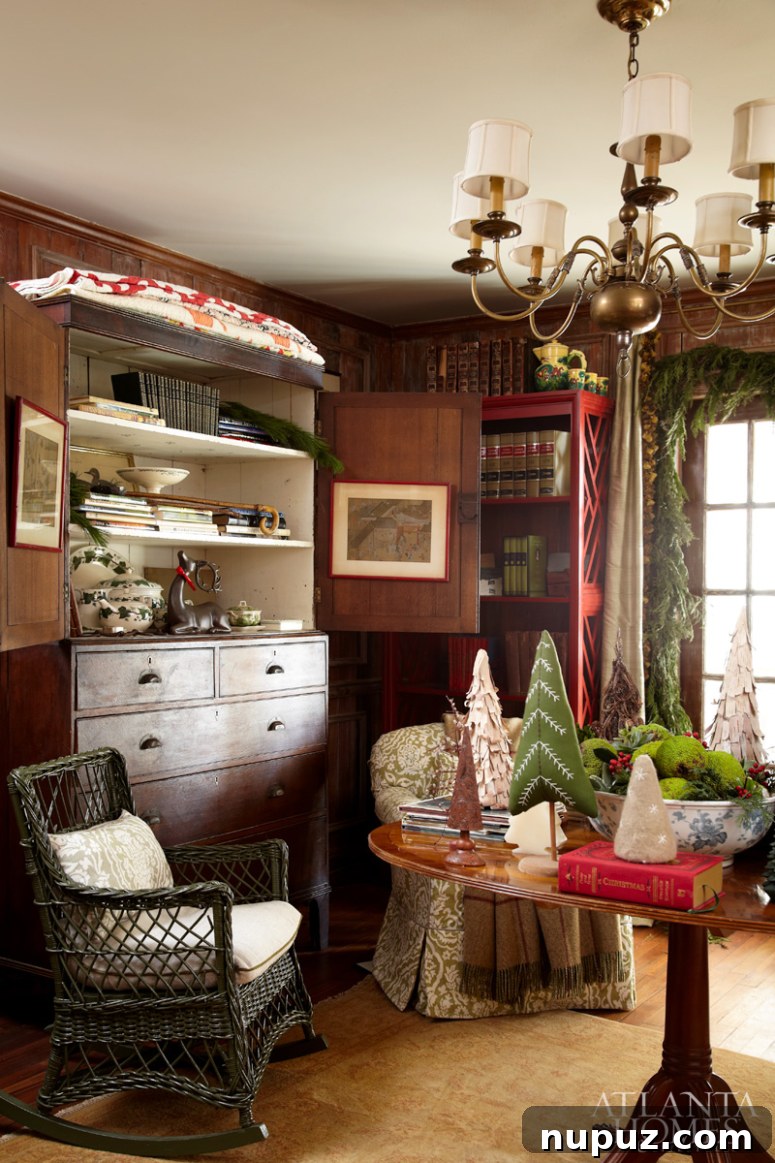 Festive Christmas mantel decor with green garland, red bows, and framed artwork, creating a cozy and traditional holiday look.
