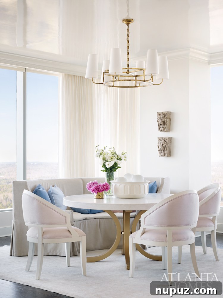 Sky-High Urban Retreat 4 Sophisticated living room with a large, inviting sofa, contemporary art, and ample natural light, showcasing Melanie Turner's tranquil design in an Atlanta condo.