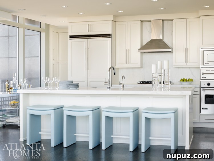 Sky-High Urban Retreat 6 Modern and minimalist kitchen in an Atlanta condo, with sleek cabinetry, integrated appliances, and clean lines, embodying functional elegance for urban living.