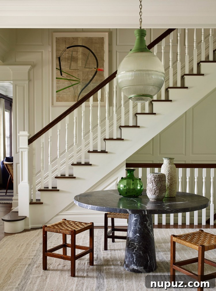 Timothy Brown Studio: Elevated Aesthetics 11 Grand entrance hall with a round natural stone table and elegant decor